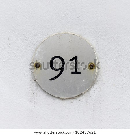 stock-photo-house-number-ninety-one-on-a-small-round-plate-attached-with-two-rusty-screws-102439621.jpg